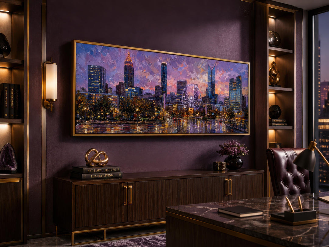 Panoramic canvas print of the Atlanta skyline at sunset in a gold frame above a dark wood sideboard.