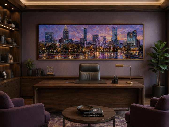 Panoramic canvas print of the Atlanta skyline at sunset above a dark wood desk in a modern office.