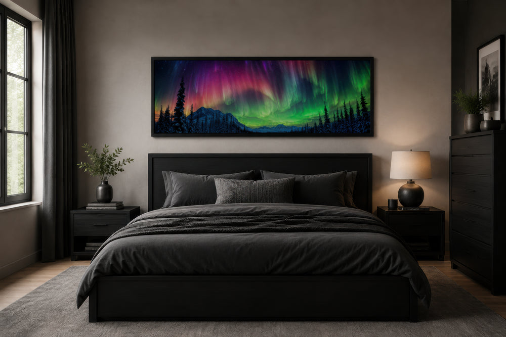 Horizontal framed canvas of the Aurora Borealis in pink and green above a dark modern bed.