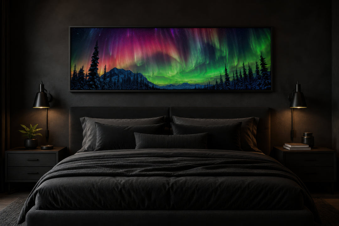 Panoramic framed canvas of the Aurora Borealis in pink and green above a dark modern bed.