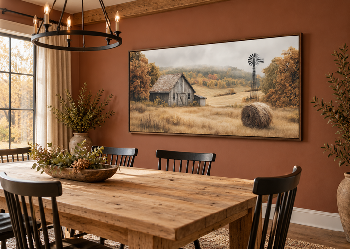 Rustic barn, hay bale, and windmill in a fall landscape canvas wall art in a dining room.