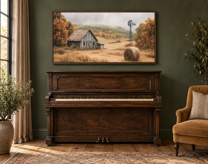 Rustic barn, hay bale, and windmill in a fall landscape canvas wall art above a vintage piano.