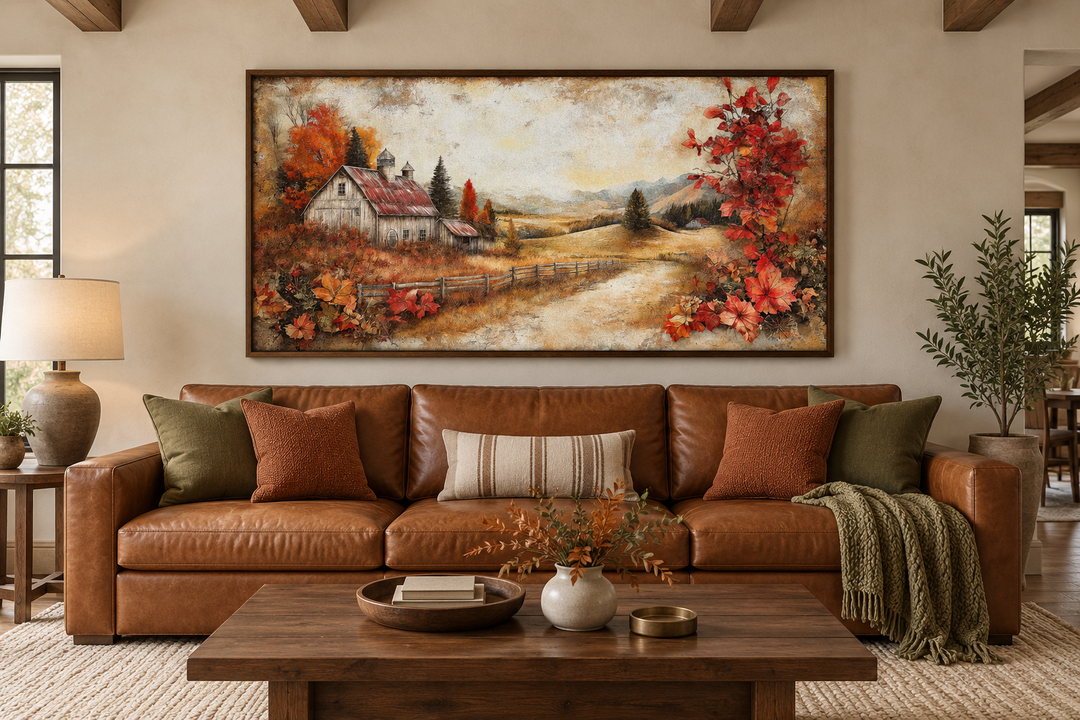 Autumn farm barn rustic canvas wall art in a walnut frame above a brown leather sofa.