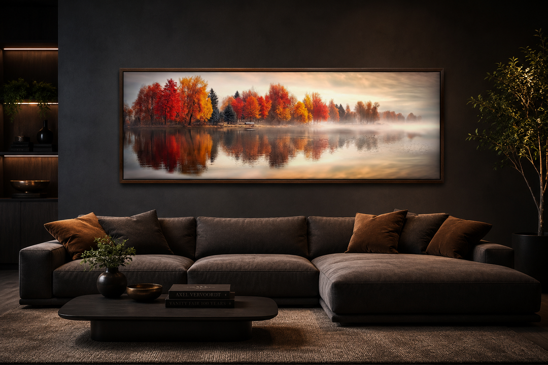 Panoramic canvas wall art of an autumn forest reflecting on a calm lake above a modern sofa.