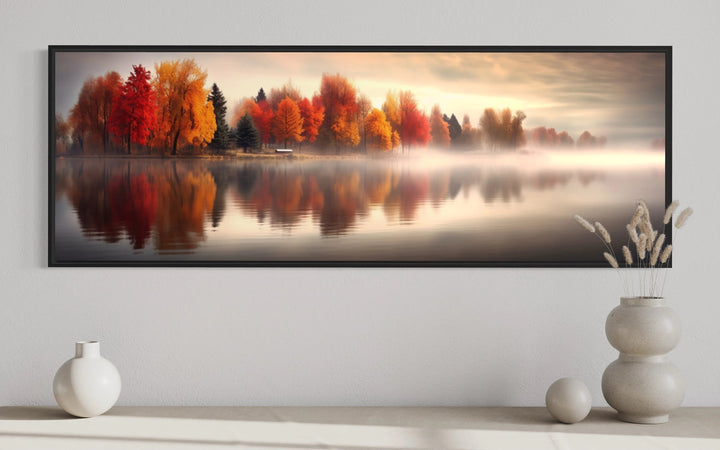 Autumn forest lake reflection long horizontal canvas wall art above a console with vases.