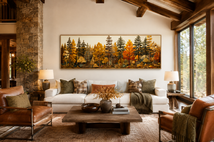 Long horizontal autumn forest painting on wood wall art above a white sofa in a rustic living room.