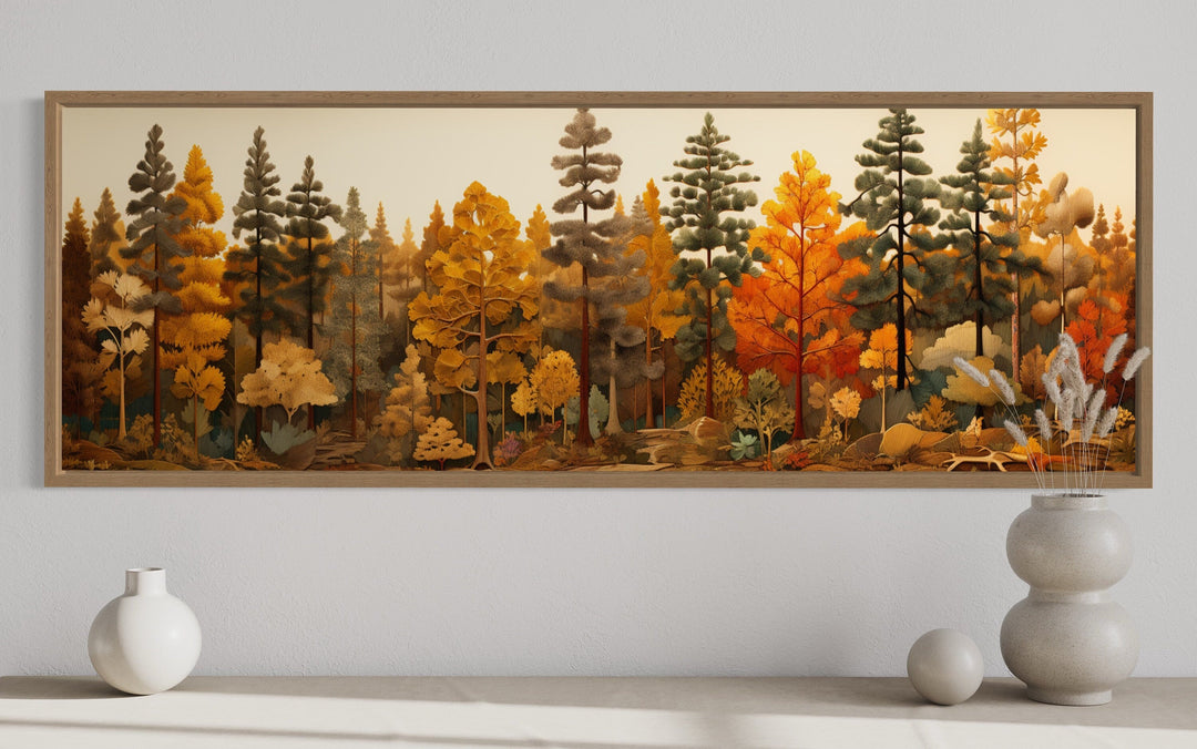 Long horizontal wood wall art of an autumn forest with golden and orange trees above a white shelf.