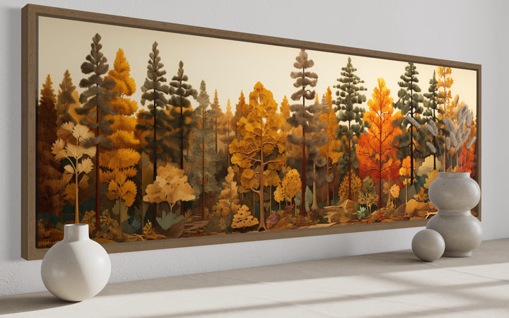 Long horizontal wood wall art of an autumn forest with golden and orange trees above a shelf.
