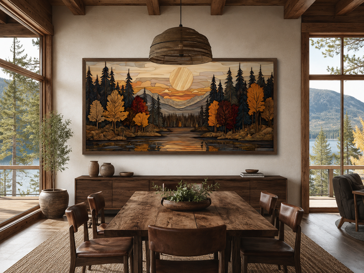 Autumn forest sunset rustic canvas wall art in a panoramic wood frame above a dining table.