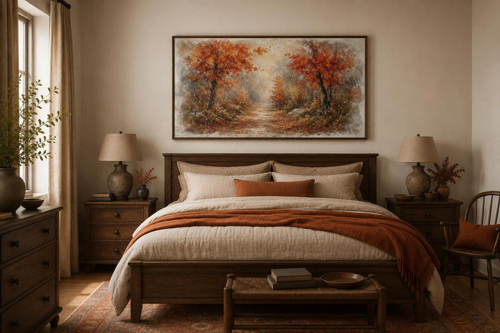 Autumn forest wall art with orange trees and misty woodland scene above a bed in a cozy bedroom.
