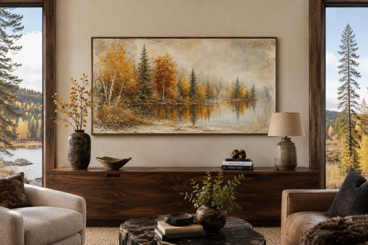 Autumn Lake Wall Art featuring a misty lake and fall forest on a canvas above a wooden sideboard.