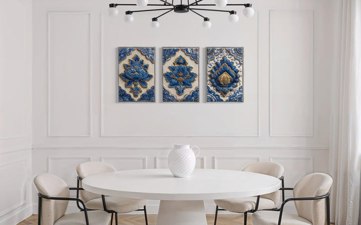 Set of three blue and gold azulejo tile canvas prints displayed on a white paneled dining room wall.