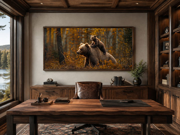 Baby bear riding mama bear in autumn forest framed canvas wall art in a rustic office setting.