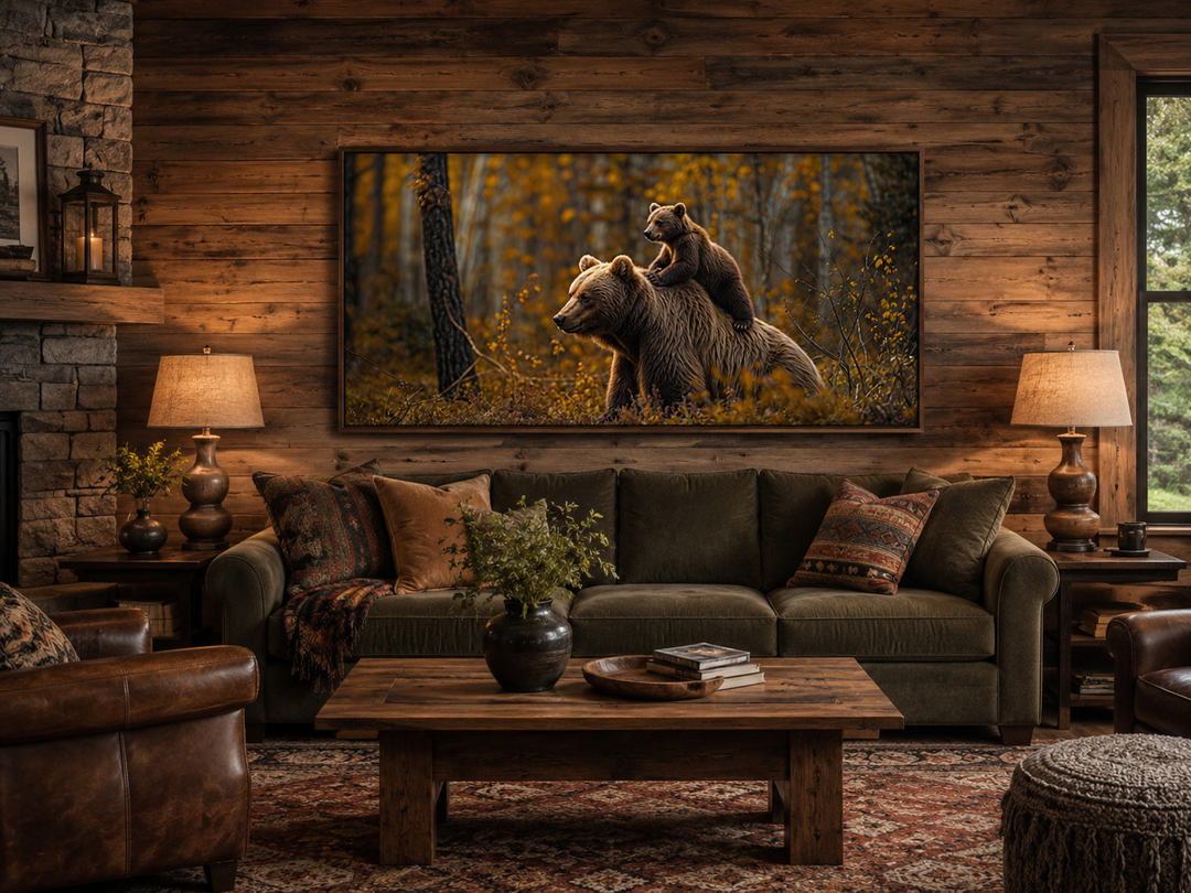 Framed canvas art of a baby bear riding a mama bear in an autumn forest, hung in a rustic cabin.
