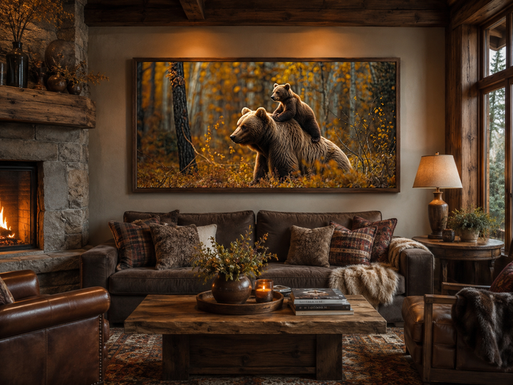 Framed canvas wall art of a baby bear riding a mama bear in an autumn forest above a brown sofa.