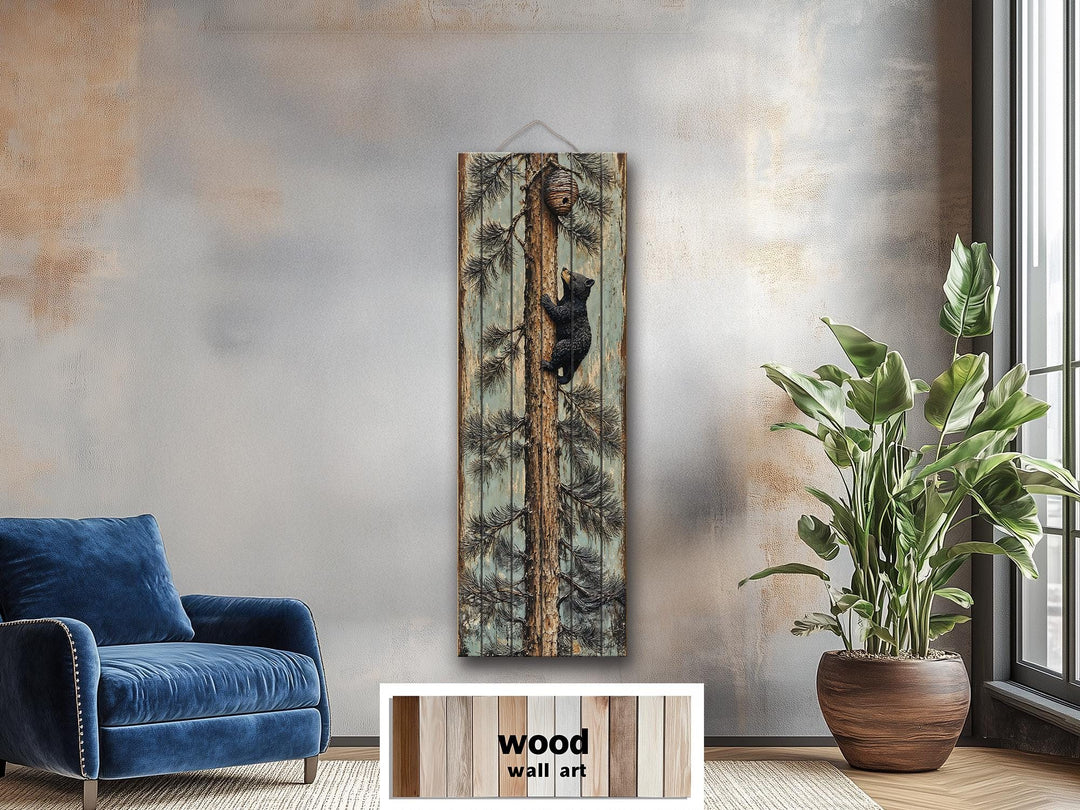 Rustic wood plank wall art featuring a baby bear climbing a pine tree in a cozy lodge setting.