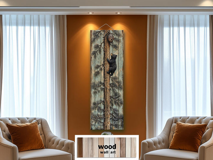 Rustic wood plank wall art featuring a baby bear climbing a pine tree in a cozy living room.