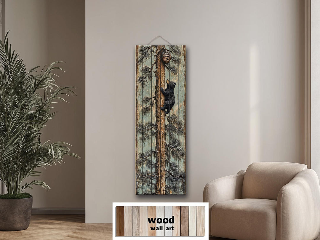 Rustic wood plank wall art featuring a baby bear climbing a pine tree toward a beehive.