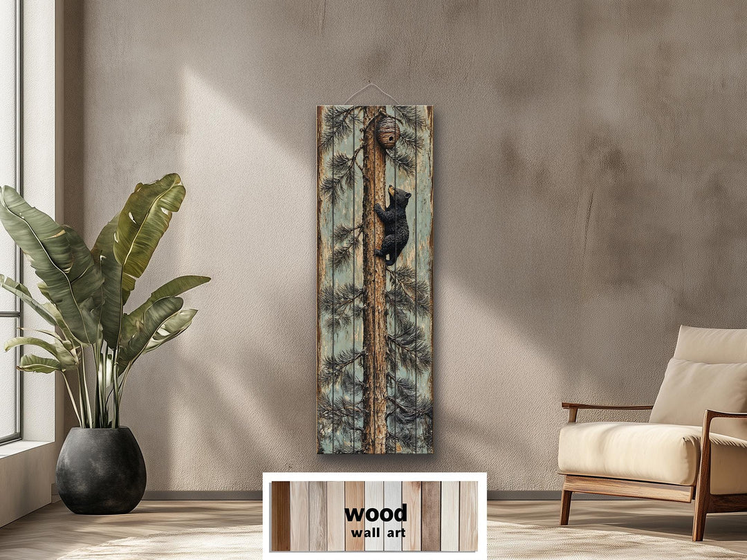 Rustic wood plank wall art featuring a baby bear climbing a pine tree in a cozy lodge setting.