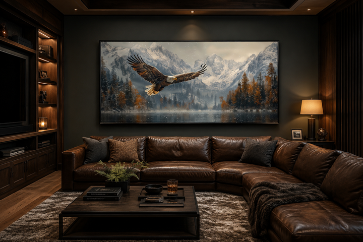 Framed canvas art of a bald eagle flying over a snowy mountain lake in a dark wood-paneled office.