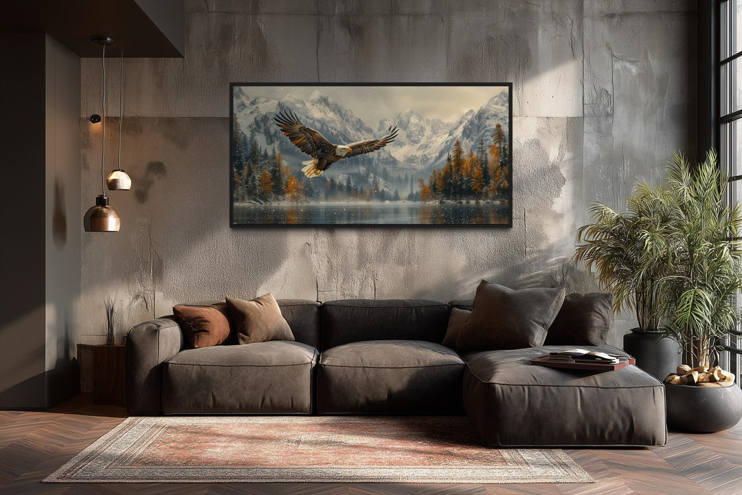 Framed wall art of a bald eagle flying over a snowy mountain lake in a modern living room.
