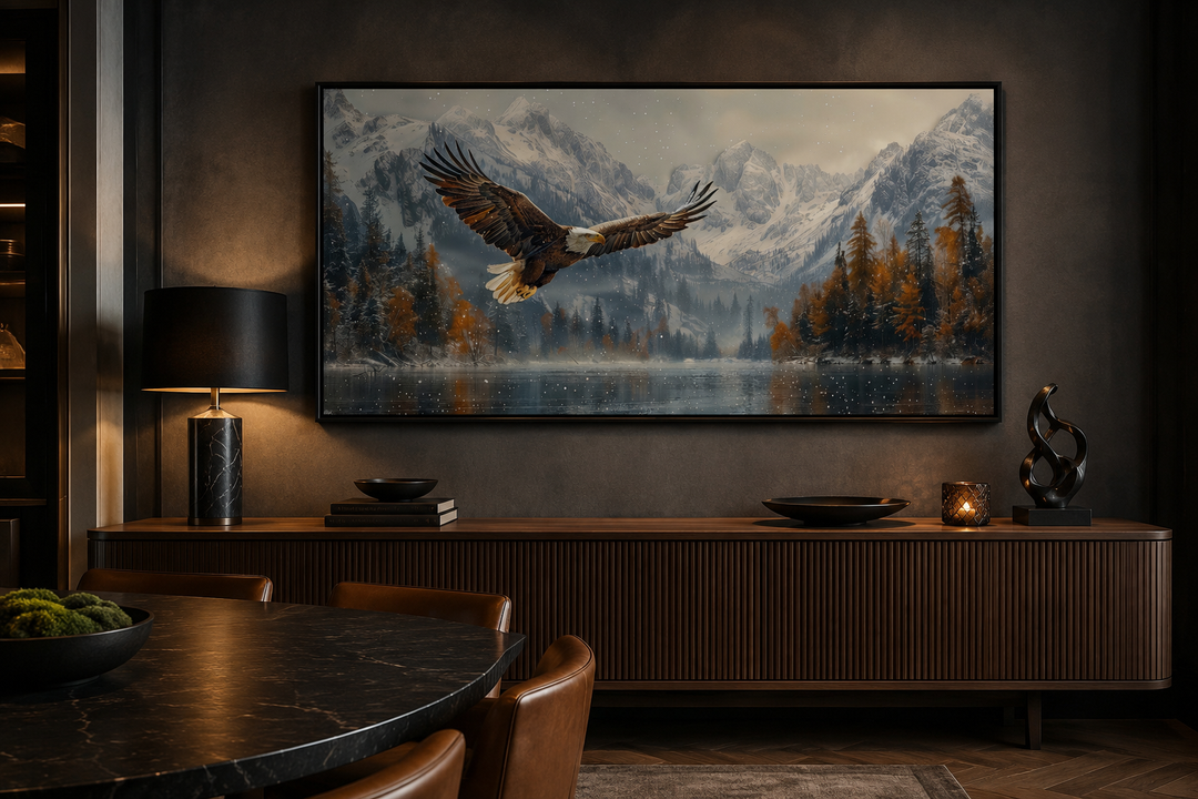 Framed wall art of a bald eagle flying over a snowy mountain lake in a dark, modern office setting.