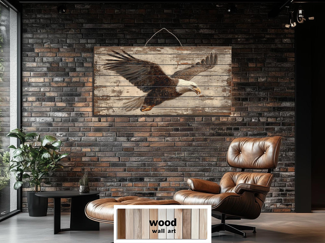 Rustic wood wall art featuring a bald eagle in flight, displayed on a dark brick wall.