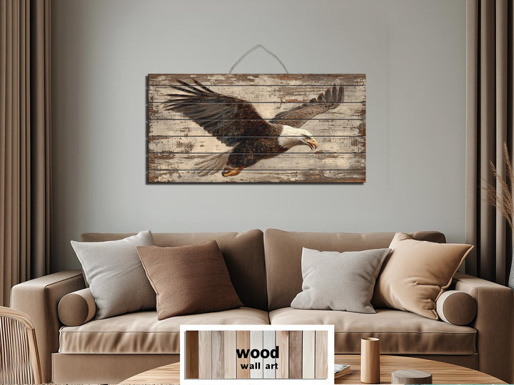 Bald eagle wall art printed on rustic distressed wood planks hanging above a tan sofa.