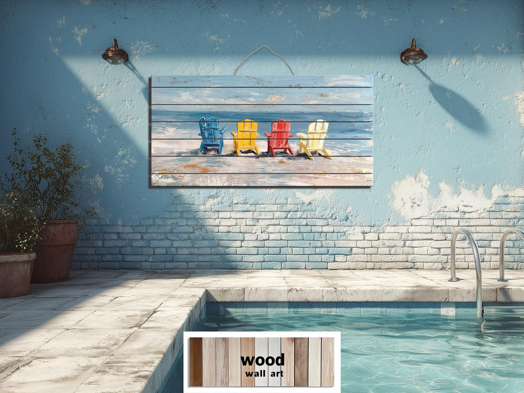 Colorful Adirondack beach chairs printed on a rustic wood wall art panel above a pool.