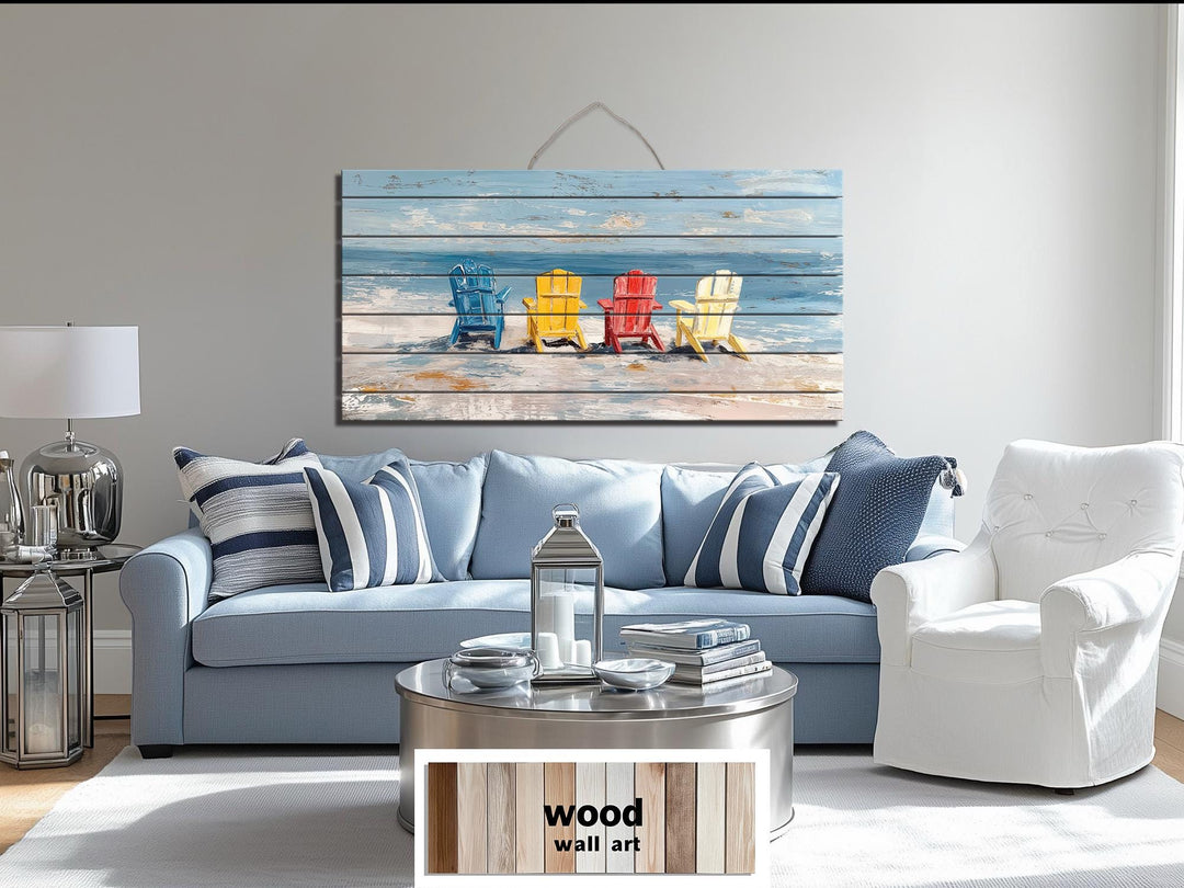 Colorful Adirondack beach chairs printed on a rustic wood wall art panel above a blue sofa.