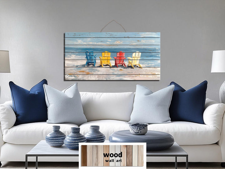 Colorful Adirondack beach chairs printed on a rustic wood wall art panel above a white sofa.