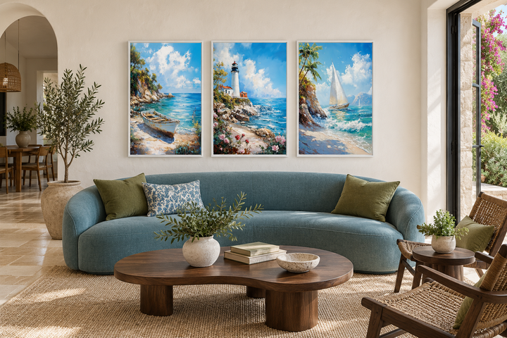 Set of 3 framed canvas prints featuring a lighthouse, sailboat, and old boat in a coastal room.