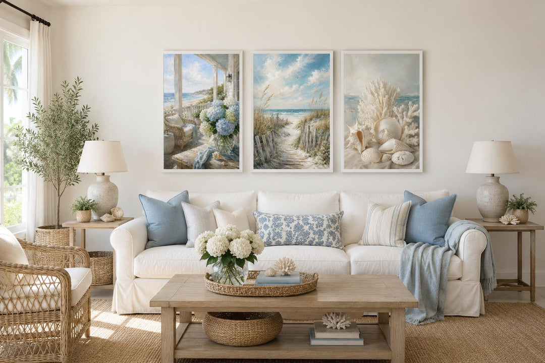 Three-piece framed coastal wall art set featuring beach scenes and shells above a white sofa.