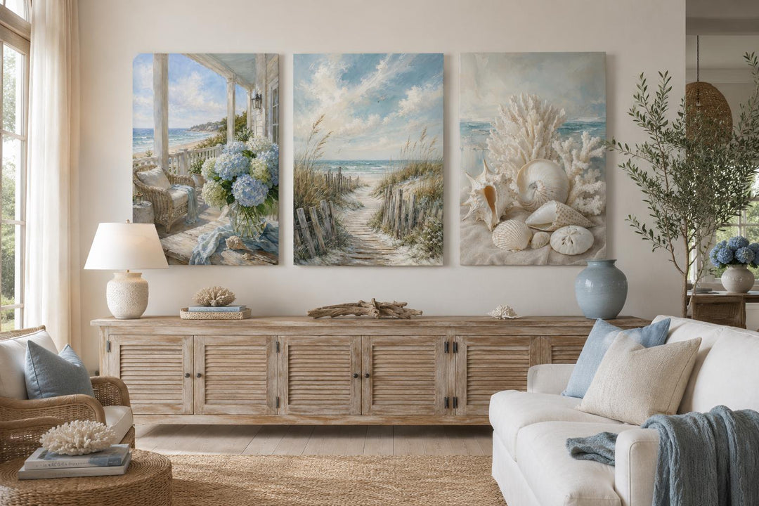 Three-piece coastal wall art set featuring a porch view, beach path, and seashells above a console.