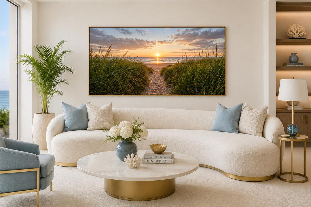 Beach Sunset, Grass And Sand Dunes Coastal Canvas Wall Art above a curved white sofa.
