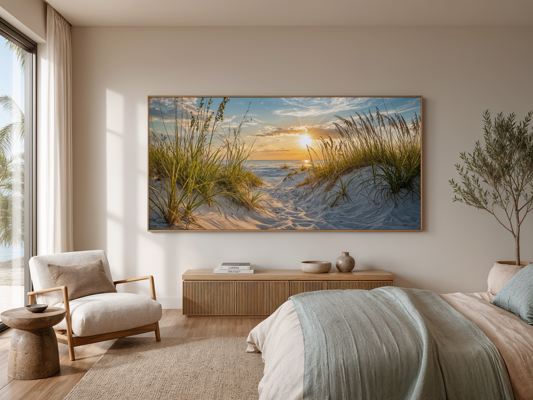 Framed beach sunset wall art featuring sand dunes and coastal grass above a wooden console table.