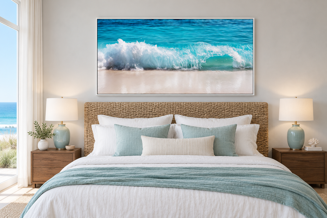 Ocean wave photography coastal framed canvas wall art hanging above a bed in a beach-themed bedroom.