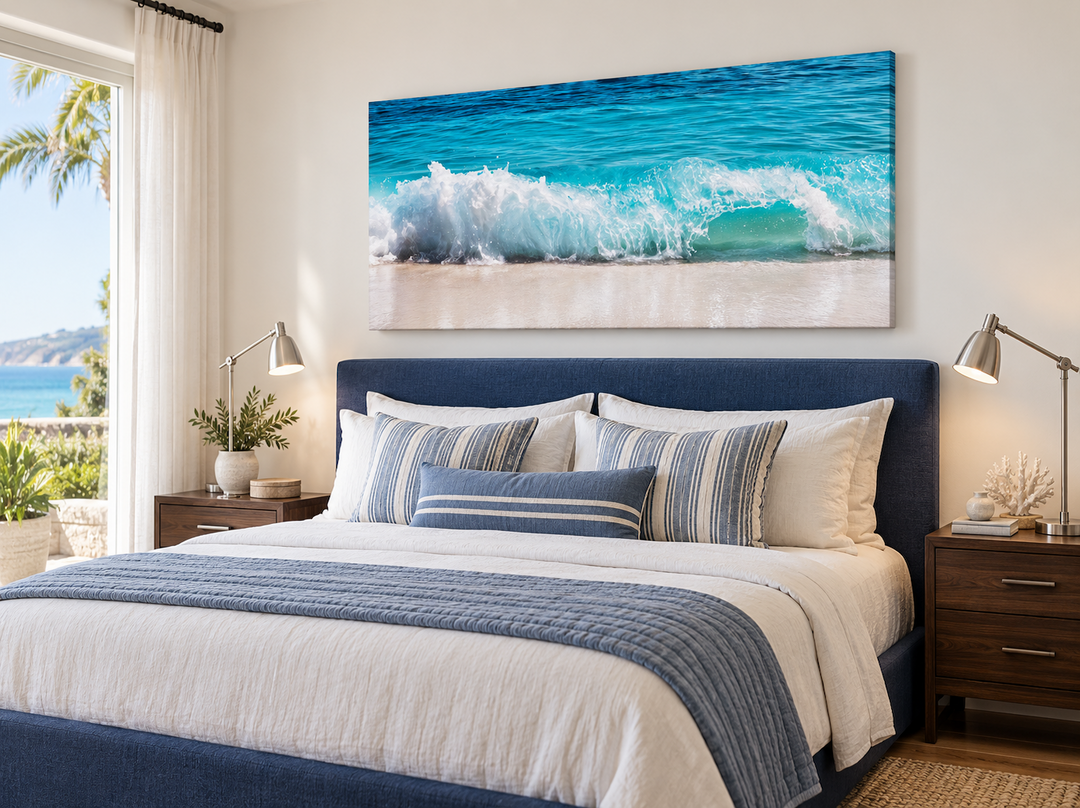 Ocean wave photography coastal framed canvas wall art hanging above a blue bed in a bedroom.
