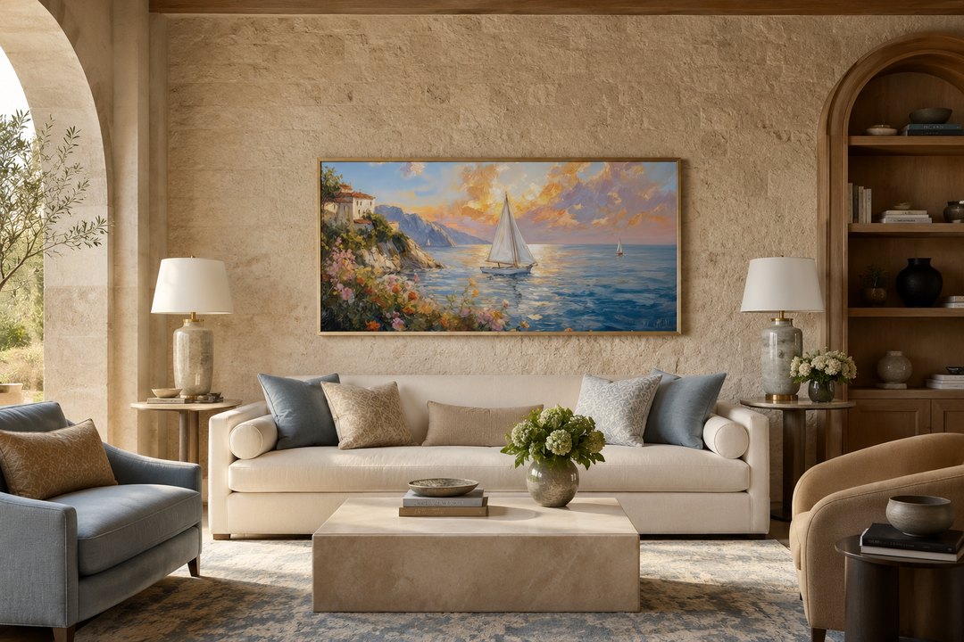 Modern coastal framed canvas print of a seascape with sailboats at sunset above a white sofa.