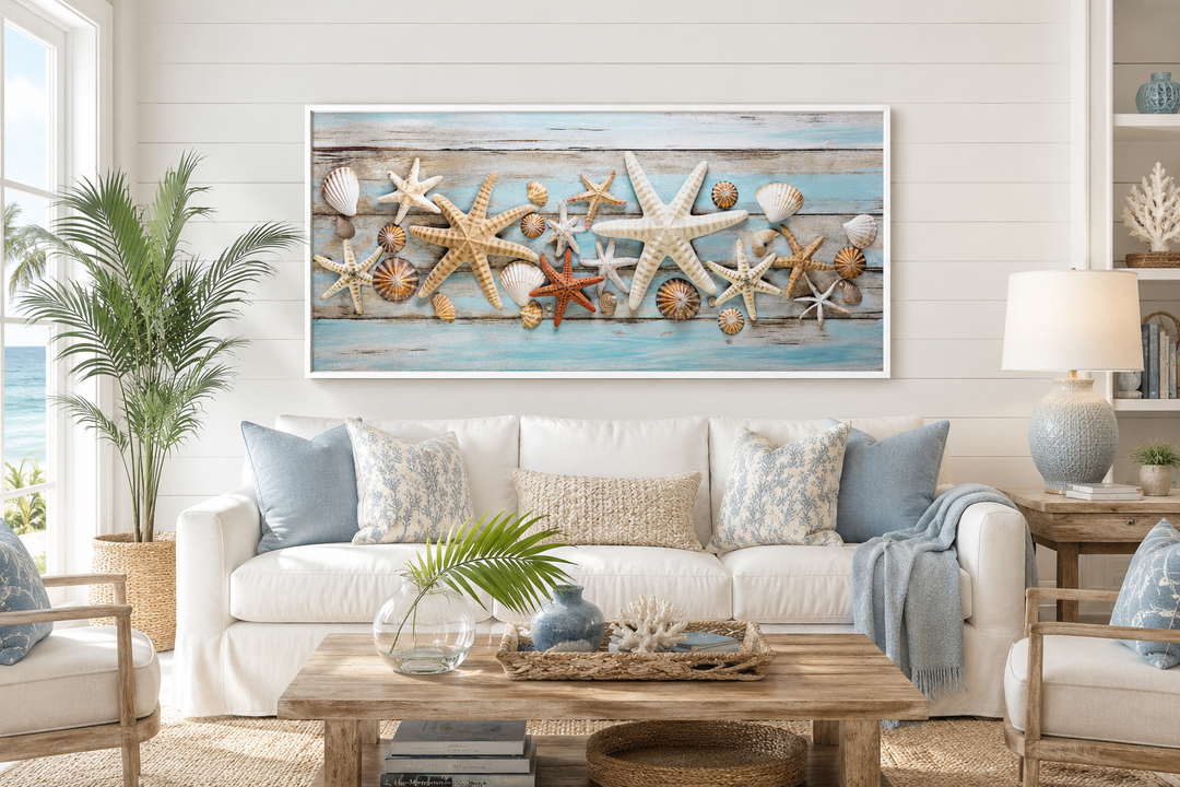 Framed horizontal starfish and seashells wall art on blue wood texture above a white coastal sofa.