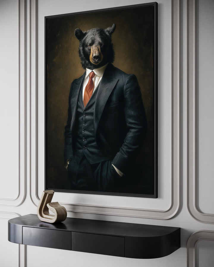 A framed canvas painting of a bear in a tailored suit hangs on a wall above a modern black console.