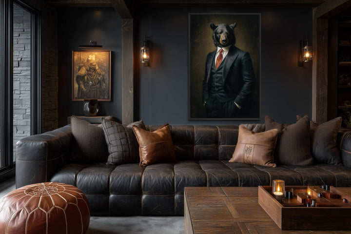 A framed canvas painting of a bear in a formal suit hangs in a dark, masculine living room.