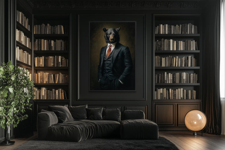 A framed canvas painting of a bear in a suit hangs in a dark, modern library with black bookshelves.