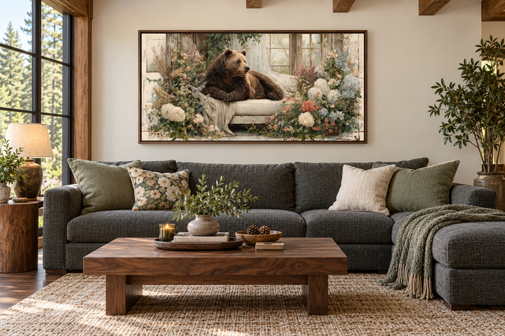 Bear on Couch Floral Canvas Wall Art in a rustic living room with a dark gray sectional sofa.