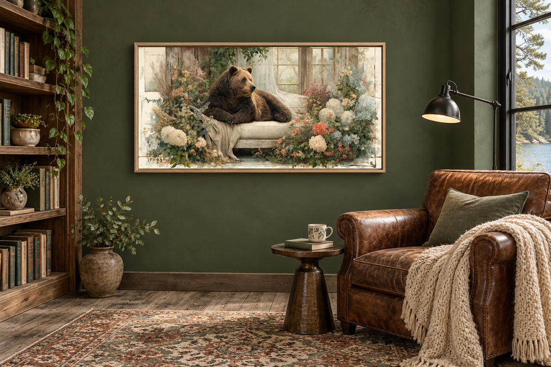 Bear on Couch Floral Canvas Wall Art in a rustic living room with a leather chair and bookshelves.