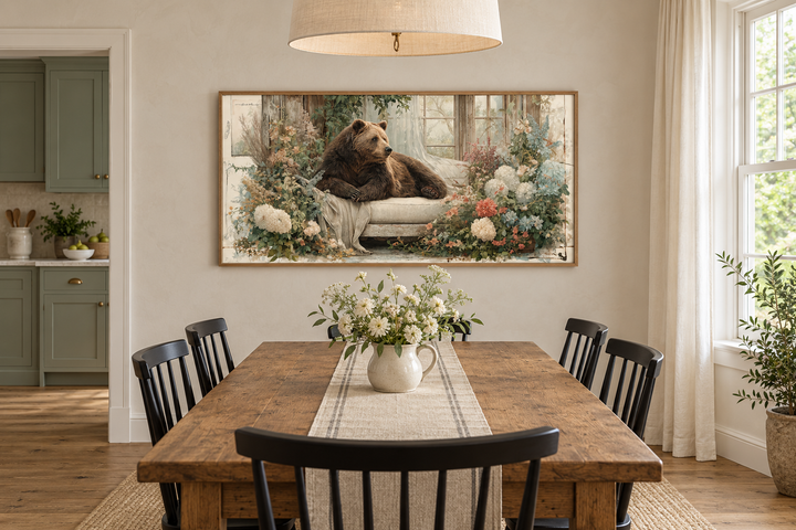 Bear on Couch Floral Canvas Wall Art in a rustic dining room above a wooden table.