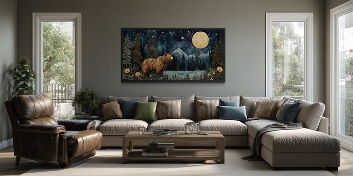 Bear in night forest wall art canvas print with full moon and mountain landscape above a sofa.