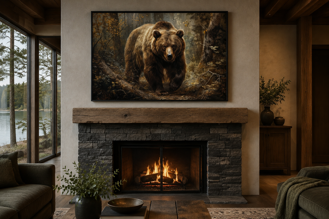 Framed canvas wall art of a bear in a forest hanging above a stone fireplace in a rustic cabin.