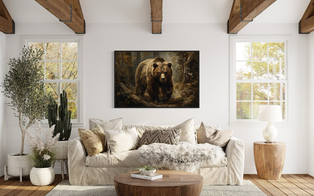 Bear in the forest vintage painting in a black frame hanging above a sofa in a rustic living room.
