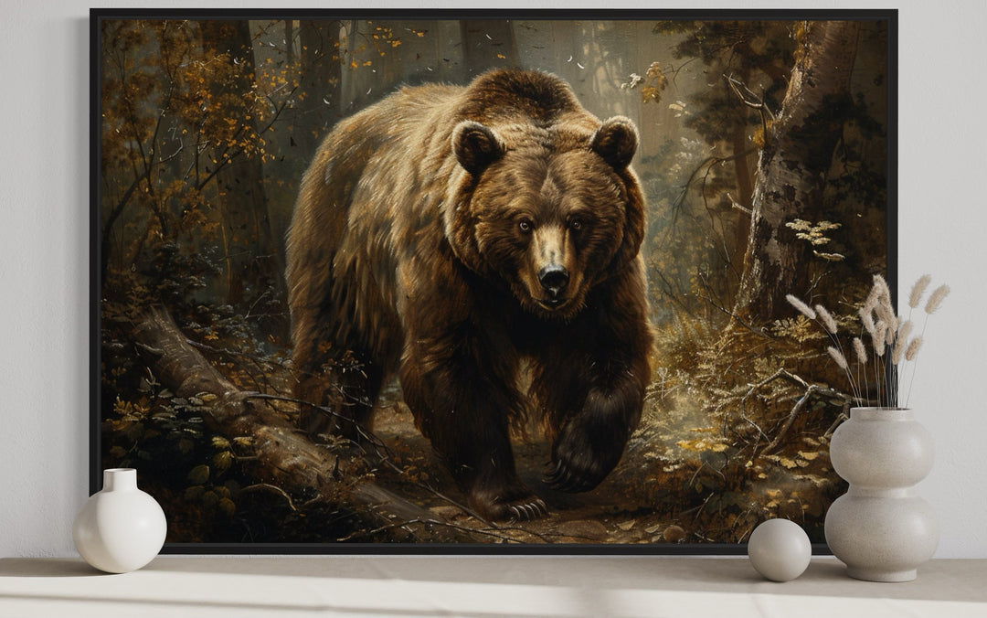 Framed canvas wall art of a brown bear walking through a vintage-style forest for cabin decor.